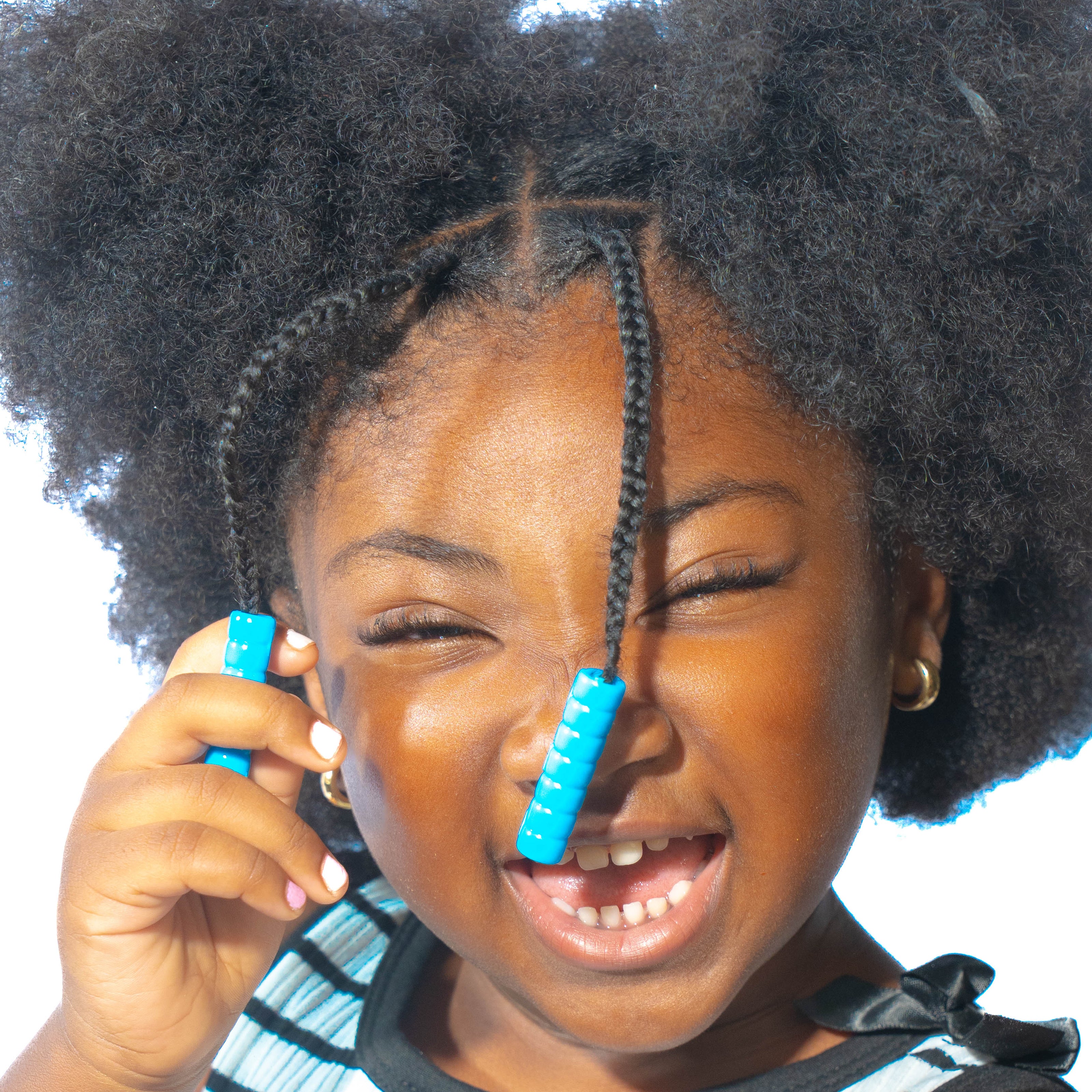 Young girl with puffy ponytails and two small braids with blue Bead Barrettes